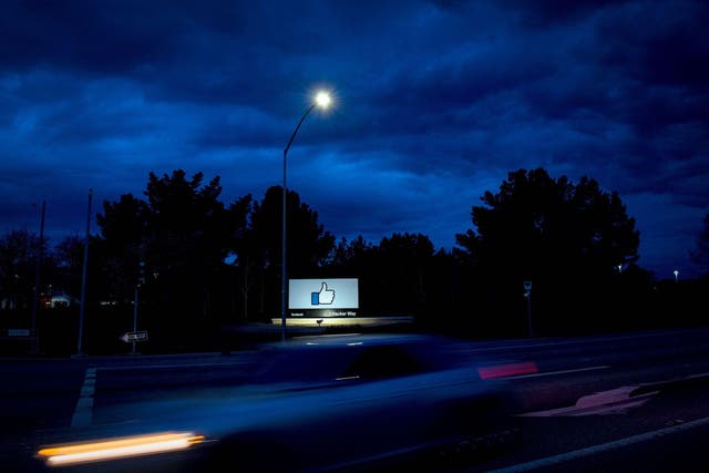 A car passes by Facebook's corporate headquarters location in Menlo Park, California, on March 21, 2018