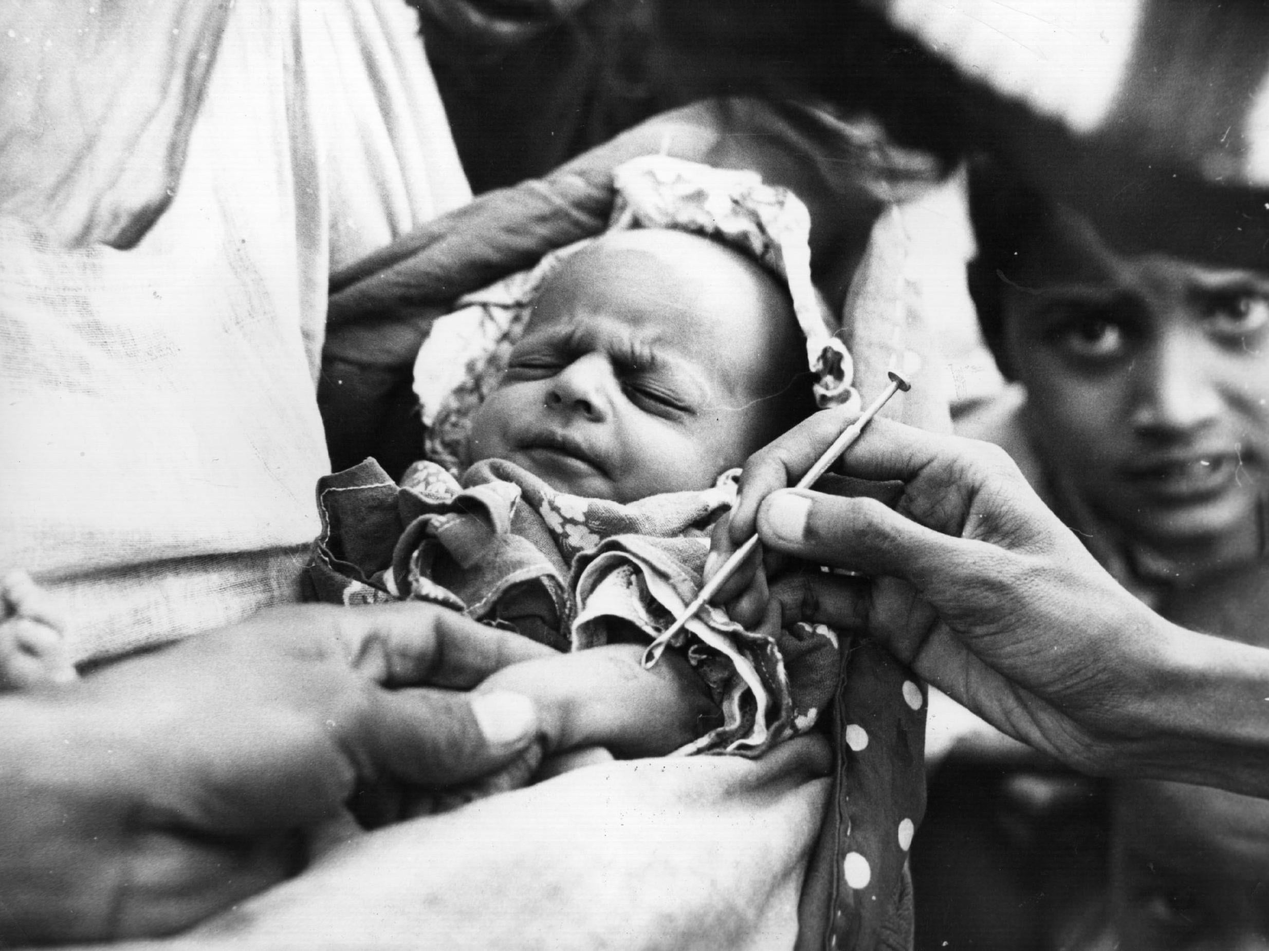 A baby is vaccinated against smallpox at an emergency clinic (Getty)