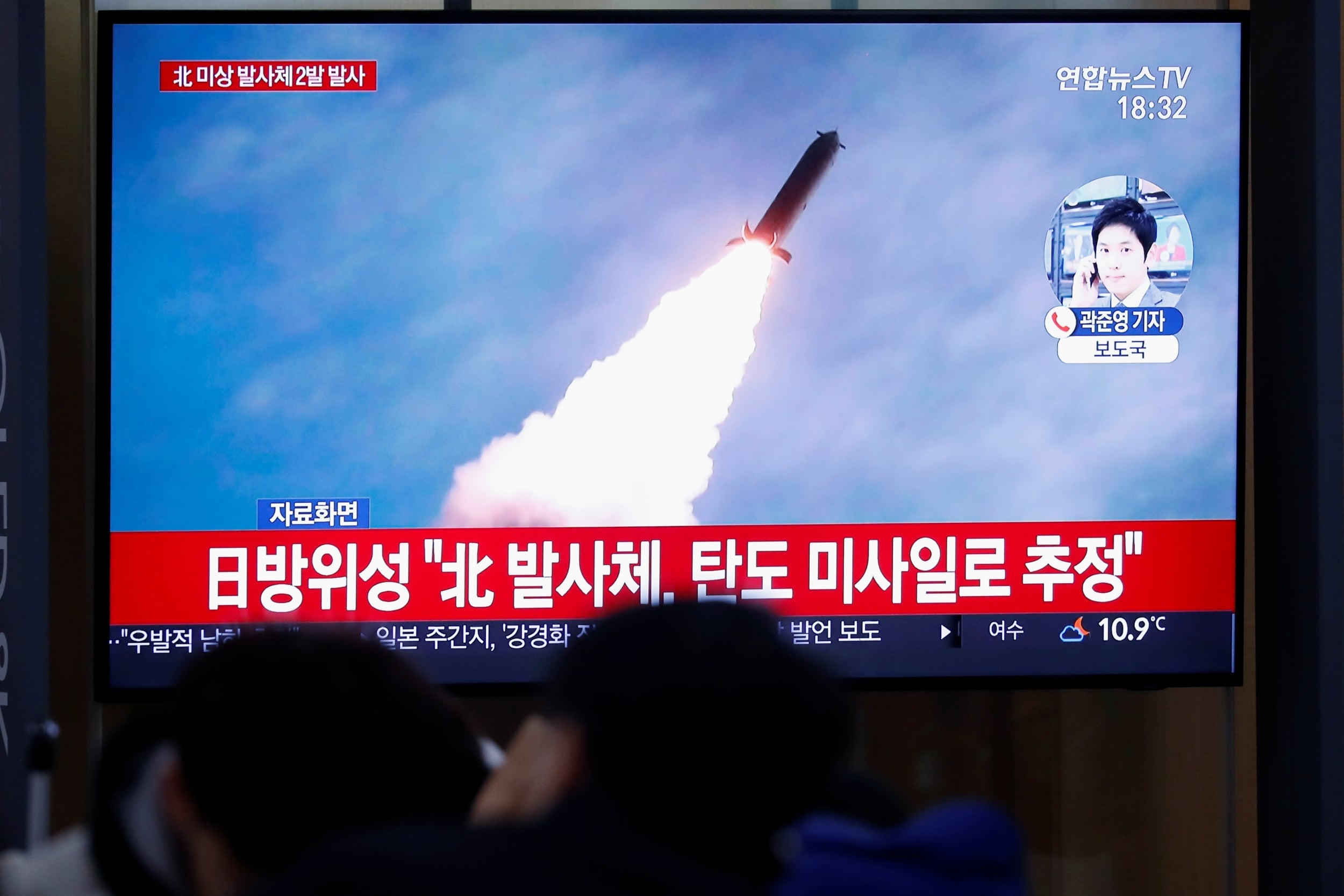 People in Seoul, South Korea, watch television footage of the launch of an unidentified projectile by North Korea