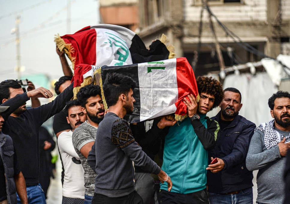 Mourners carry the coffin of a driver who was killed during clashes between anti-government protesters and security forces in Baghdad