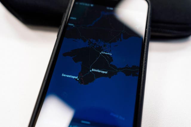 An illustration picture taken on November 28, 2019 in Moscow shows an Apple map with the Crimea peninsula on a smartphone screen