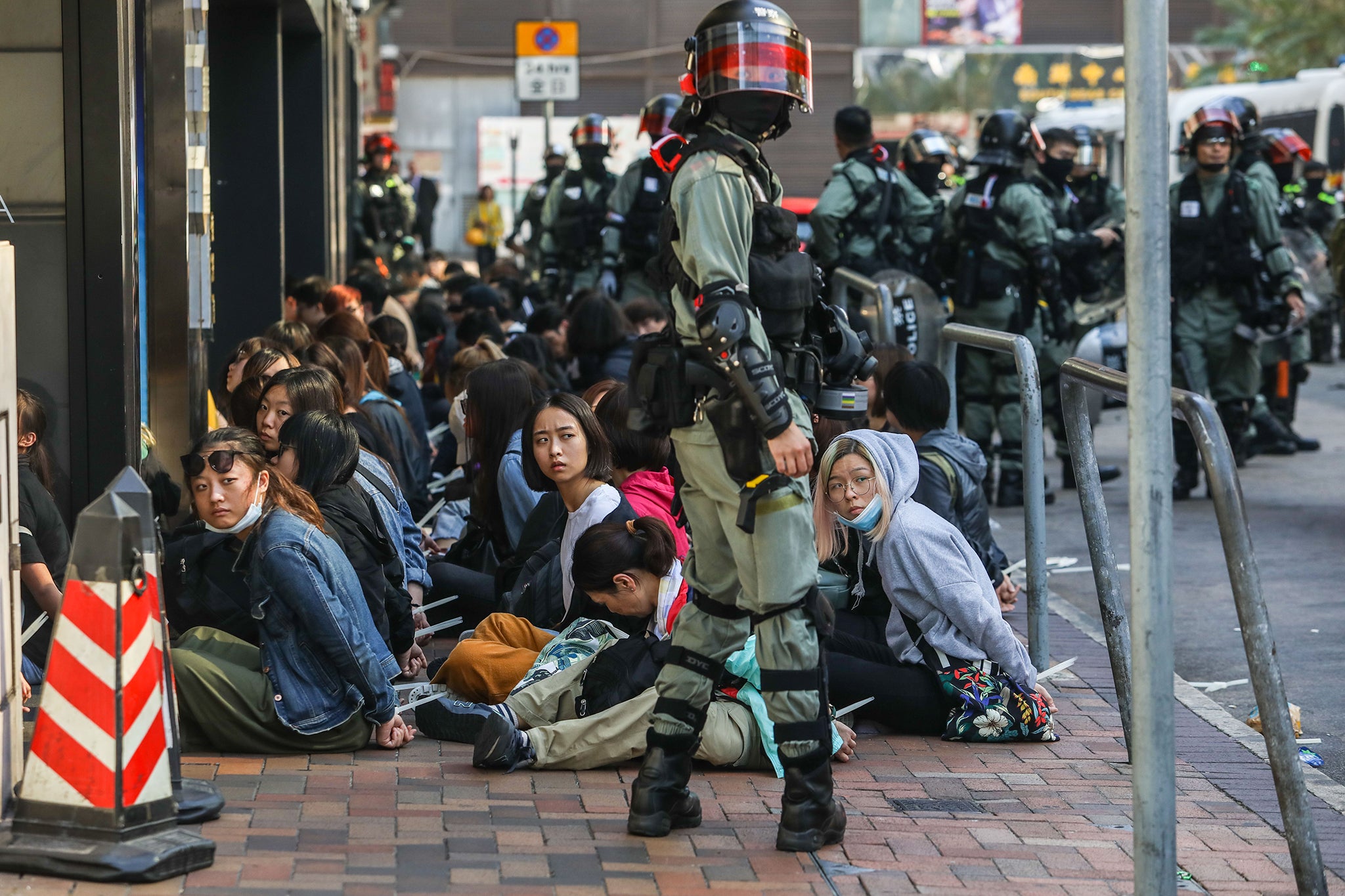 Police round up detained protesters outside the university