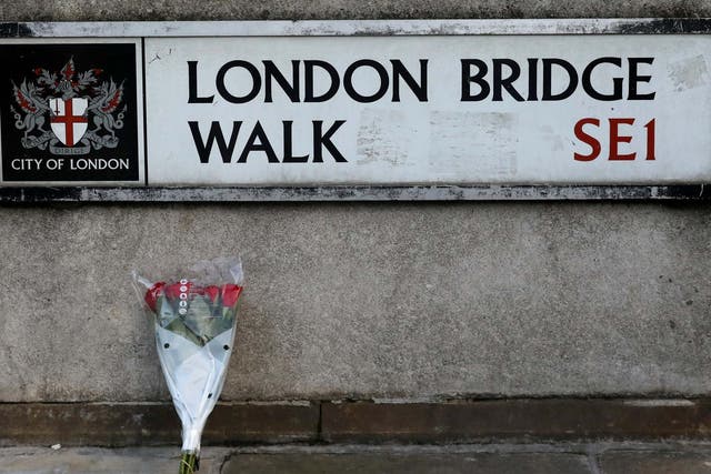 Flowers are laid down for the victims of Friday’s attack