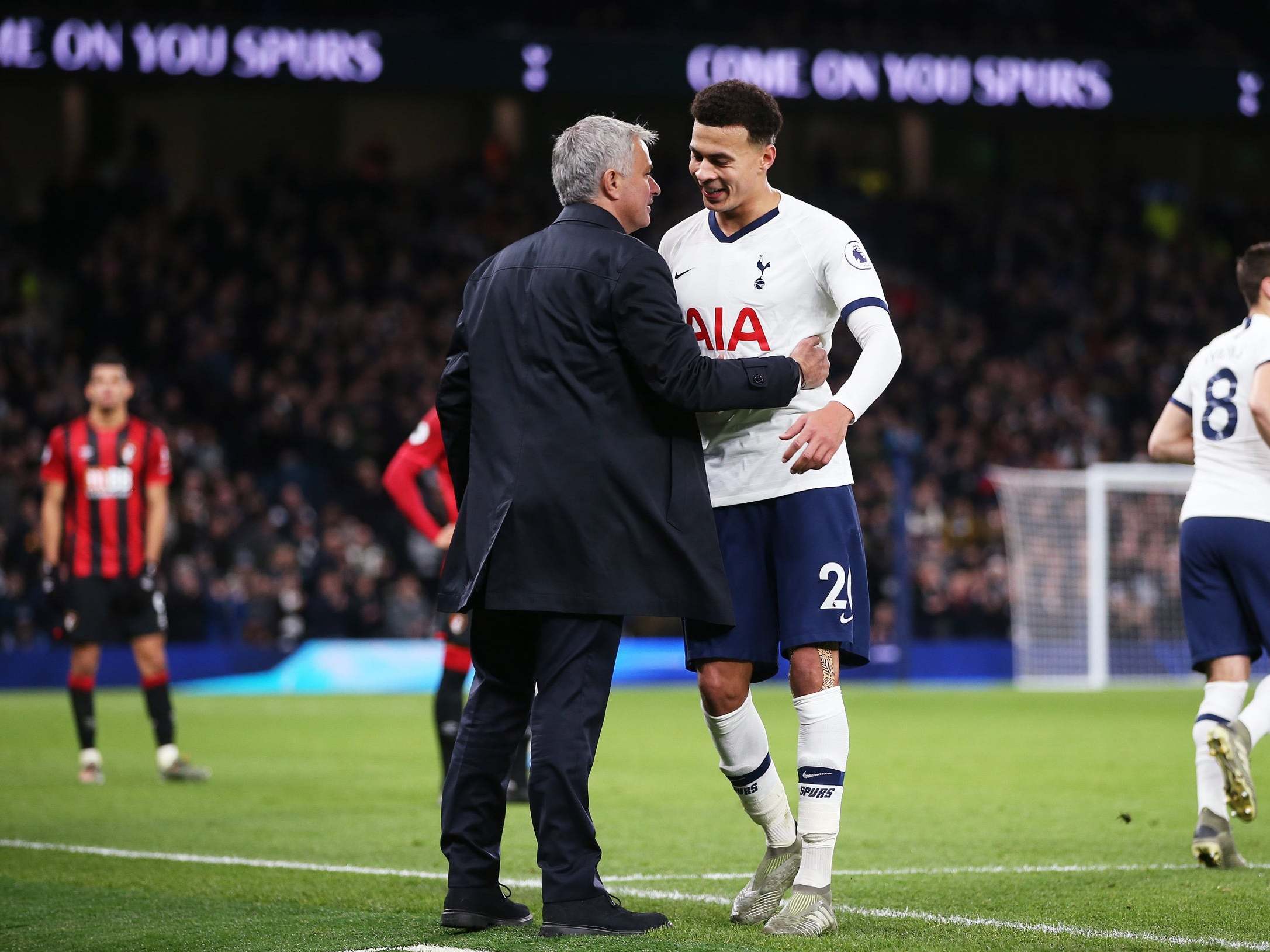 Dele Alli hugs Jose Mourinho as he leaves the field