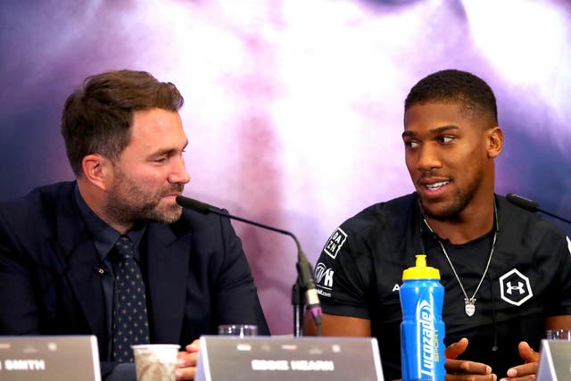 Anthony Joshua speaks with Eddie Hearn during the press conference