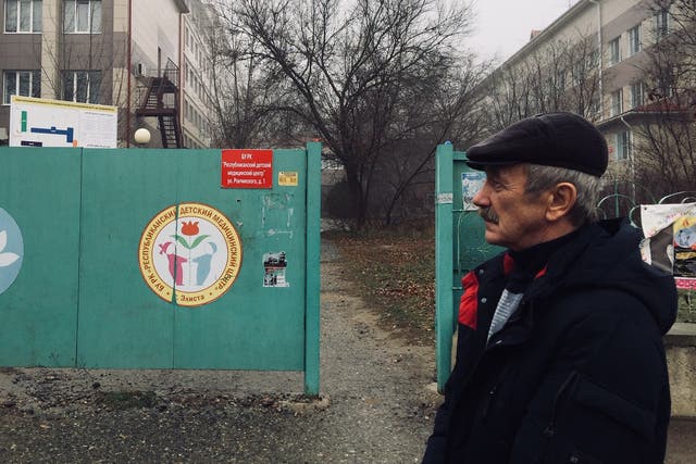 Alexander Gorobchenko stands in front of Elista’s children’s hospital where three decades ago his son Sergei was infected with HIV. Gorobchenko says the reaction of the local community “devastated” him and his family. 