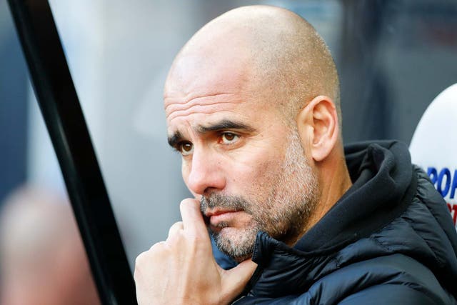 Pep Guardiola watches on from the dugout