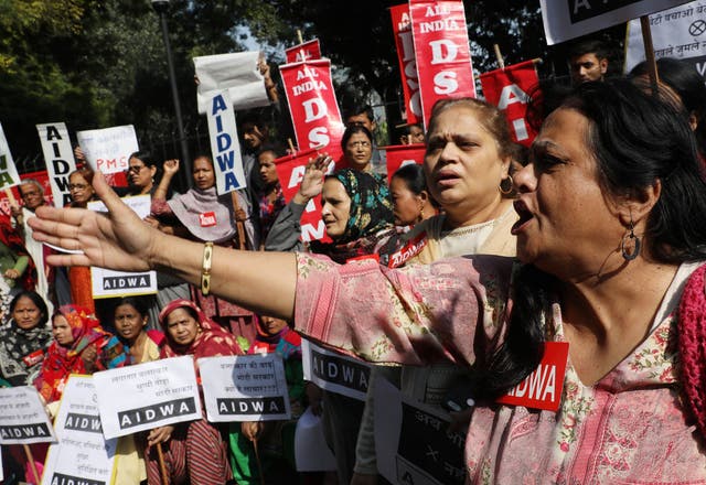 Activists hold placards and shout slogans as they protest over the Hyderabad rape case in Delhi on Monday