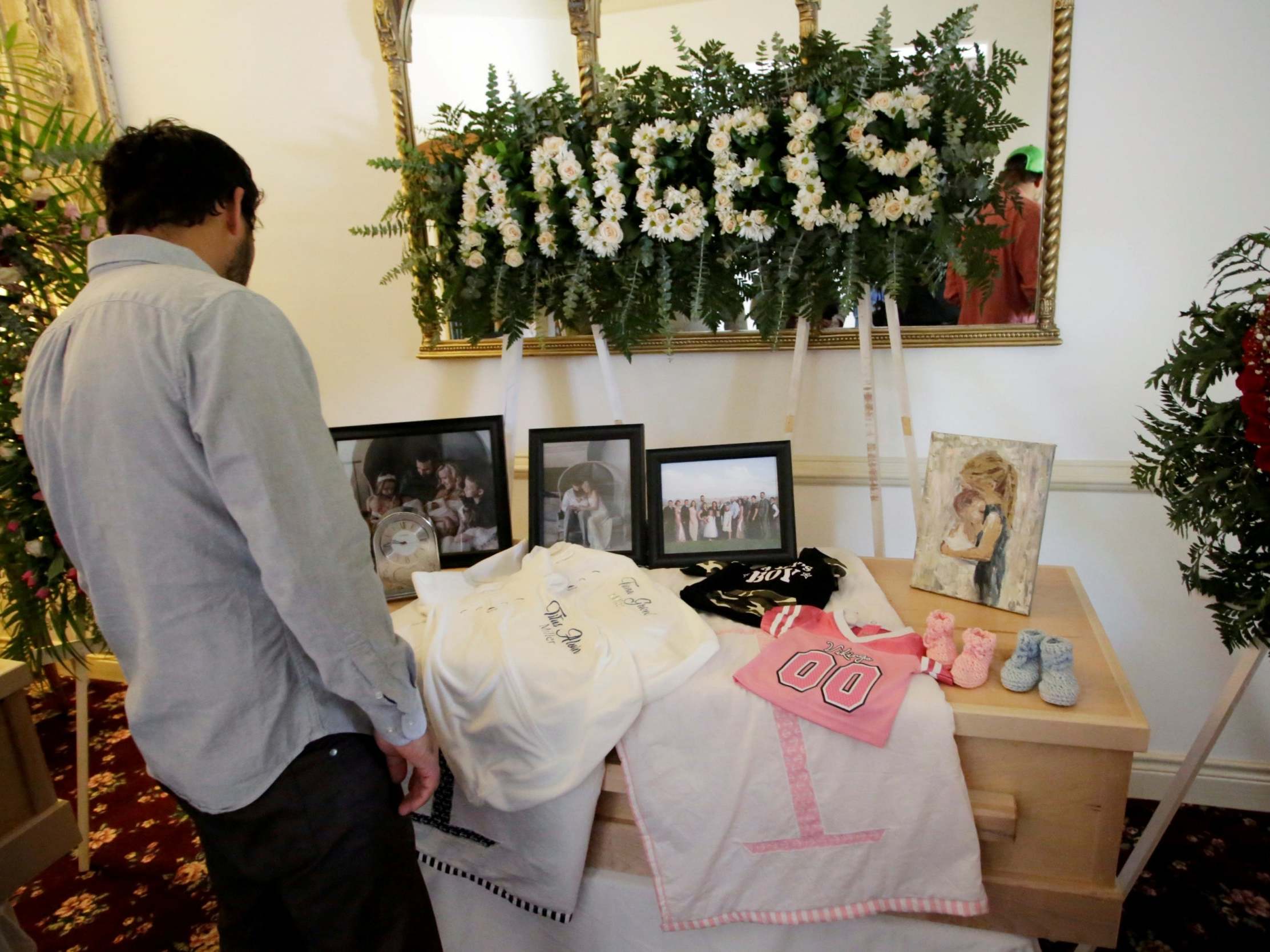 A person observes framed photographs of Rhonita Maria Miller and her four children, members of the Mexican-American Mormon community killed by unknown assailants, before her funeral in La Mora, in La Mora, Sonora state, Mexico 7 November 2019