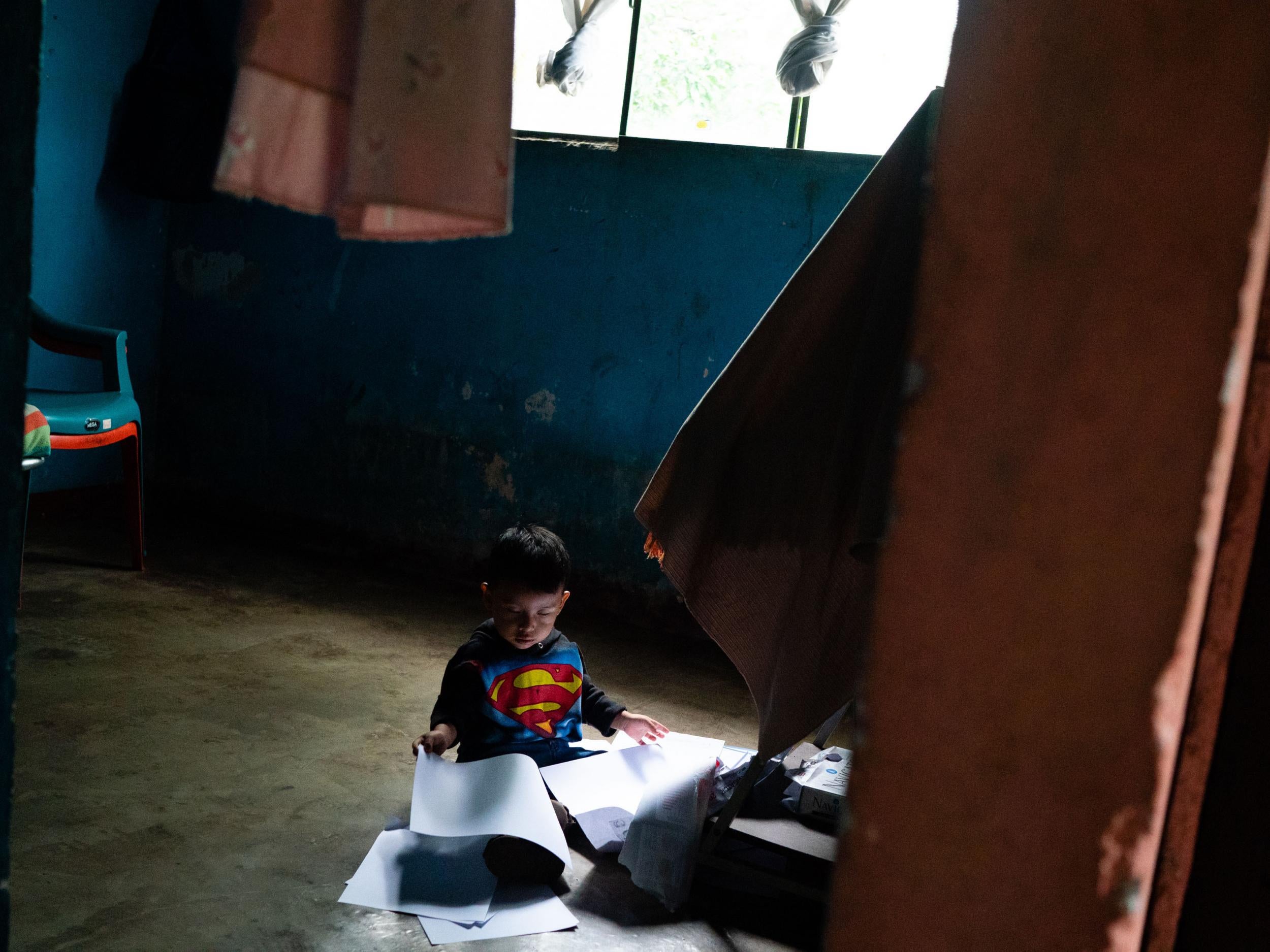 Two-year-old Keyler Herrera plays in the home of his grandfather Camposeco (The Washington Post)