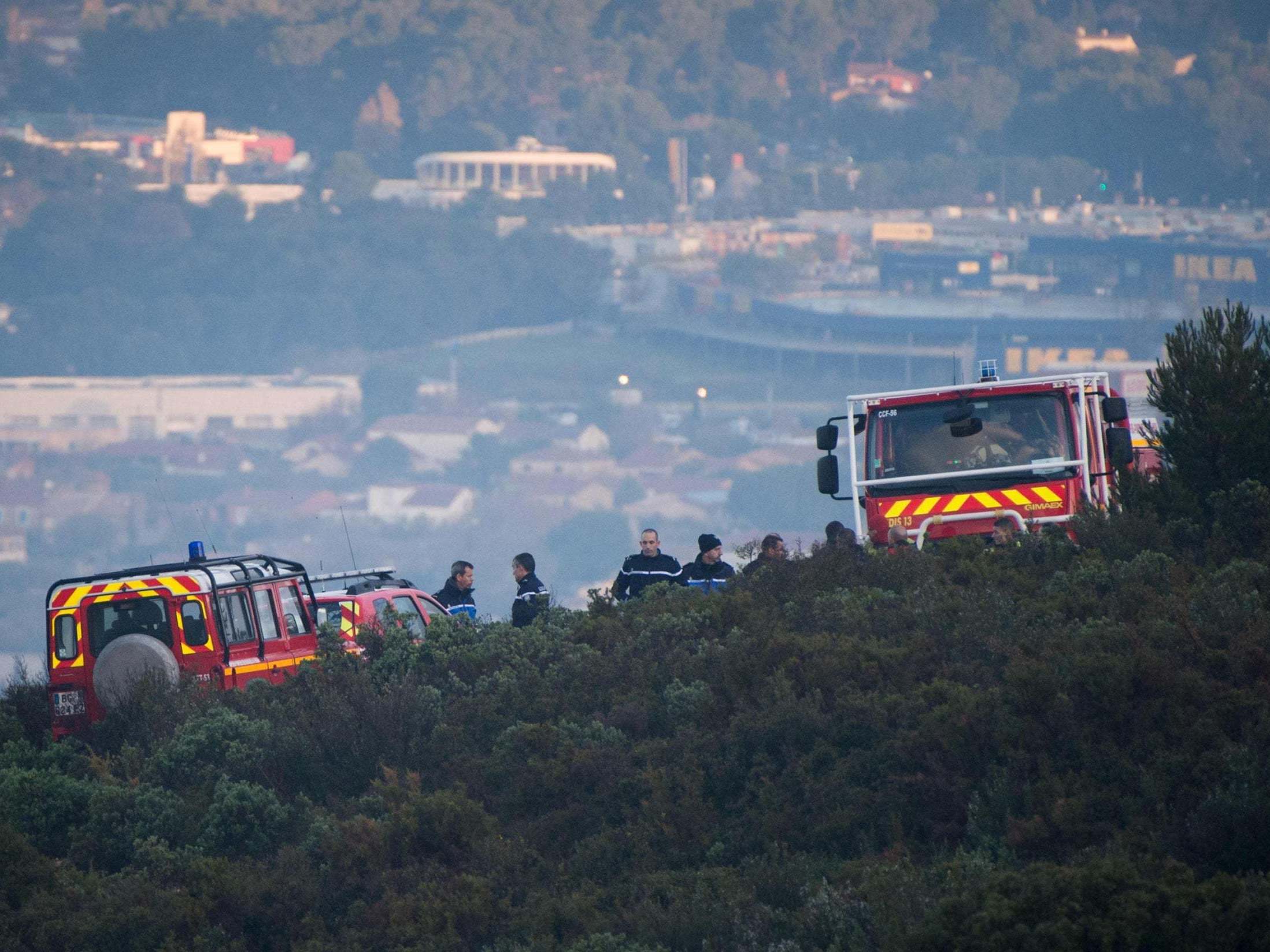 Emergency service personnel secure the area around the site where a helicopter from the civil security services crashed in the hills in Le Rove, outside Marseille, in the early hours of 2 December