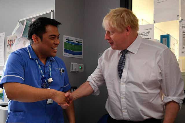 Boris Johnson shakes hands with a nurse during an election campaign visit to King's Mill NHS Hospital in Mansfield last month