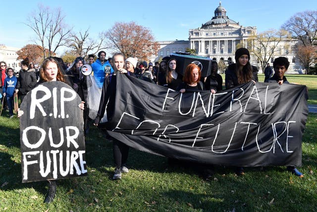 Young activists take part in a rally to protest against Climate change outside the US Capitol in Washington