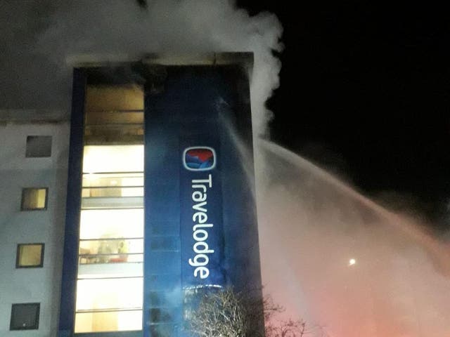 Firefighters work in challenging conditions to get the fire at the Travelodge in Brentford under control