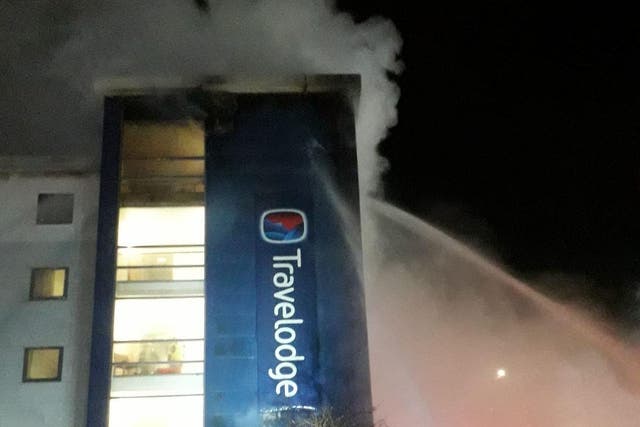Firefighters work in challenging conditions to get the fire at the Travelodge in Brentford under control