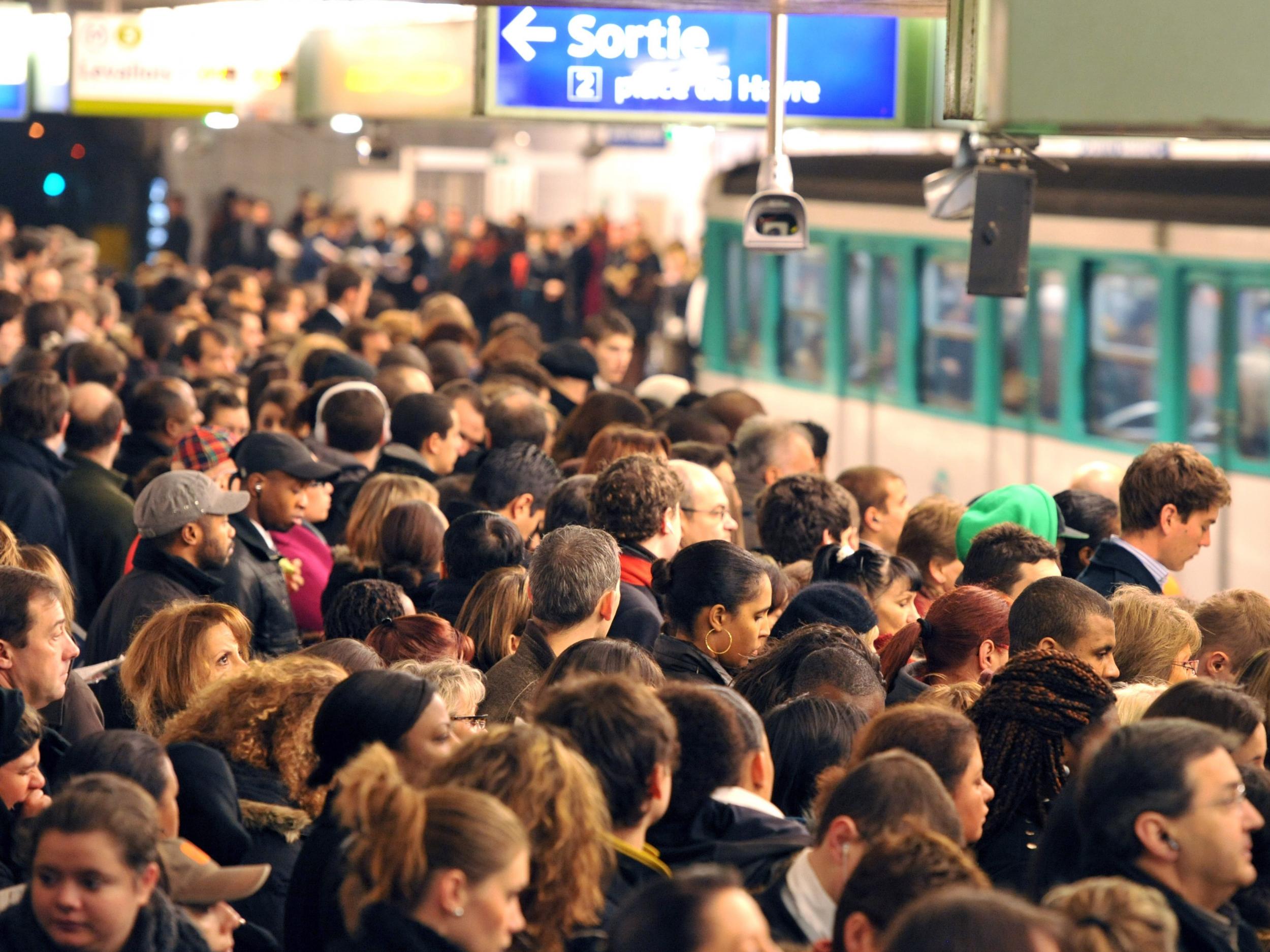 Commuters wait on a crowded platform at Saint-Lazare metro station during delays caused by strike action in Paris on 11 December, 2009