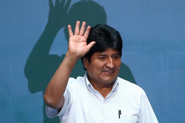 Evo Morales waves during an event to distinguish him as honorary guest at City Hall in Mexico City