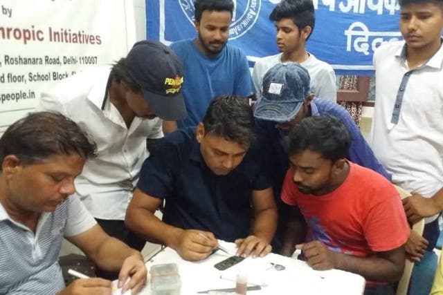 Rough sleepers take part in a mobile-phone repair course run by Delhi's leading homeless charity