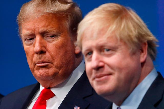 Britain's Prime Minister Boris Johnson (R) welcomes US President Donald Trump (L) to the NATO summit