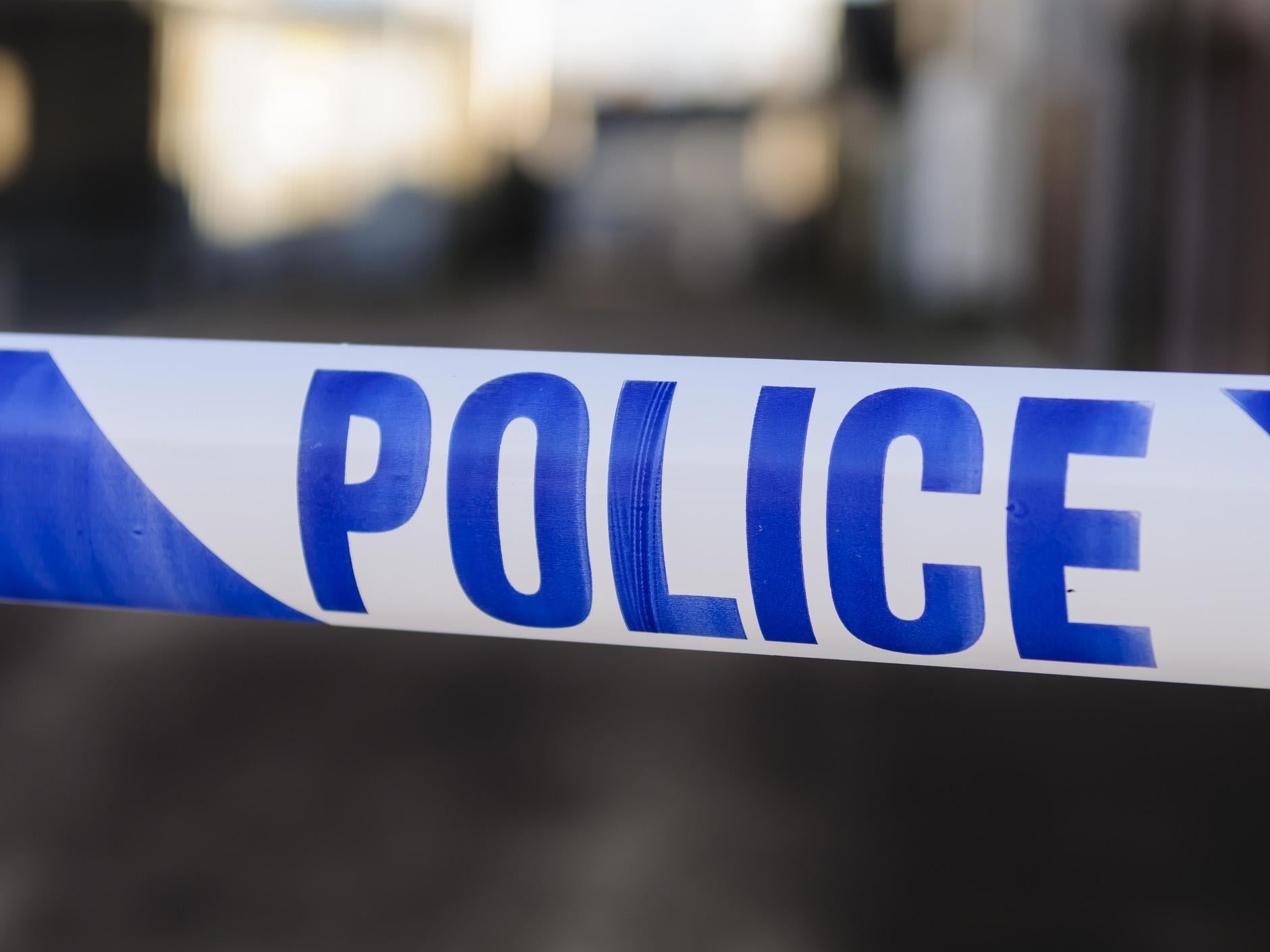 Police tape at the cordon across a crime scene