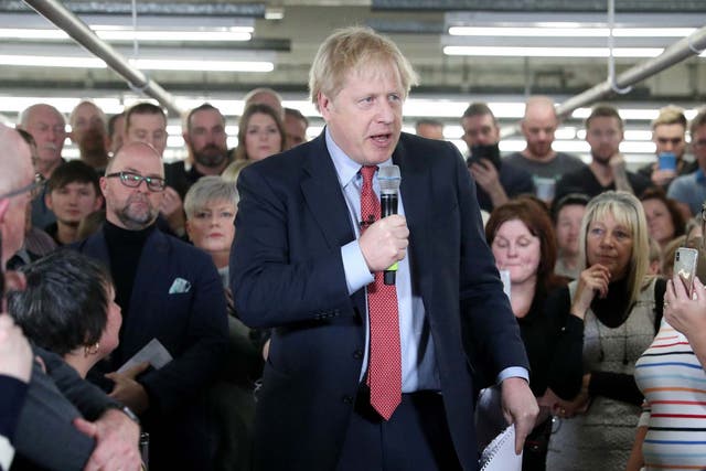 Boris Johnson speaks to workers during a Conservative Party general election campaign
