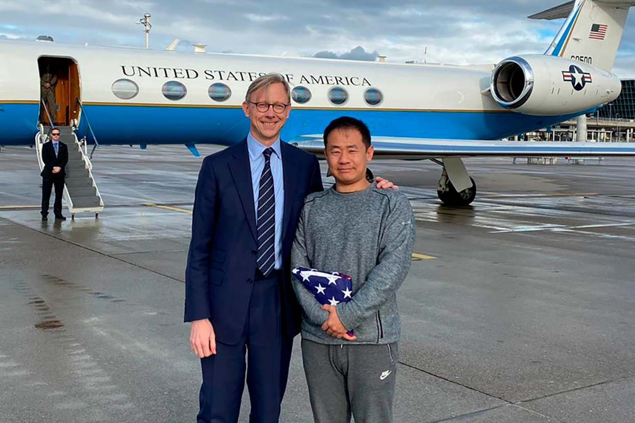 Xiyue Wang, right, with Brian Hook, the US representative for Iran, at an airport in Zurich, Switzerland, following his release from jail in Iran as part of a prisoner swap
