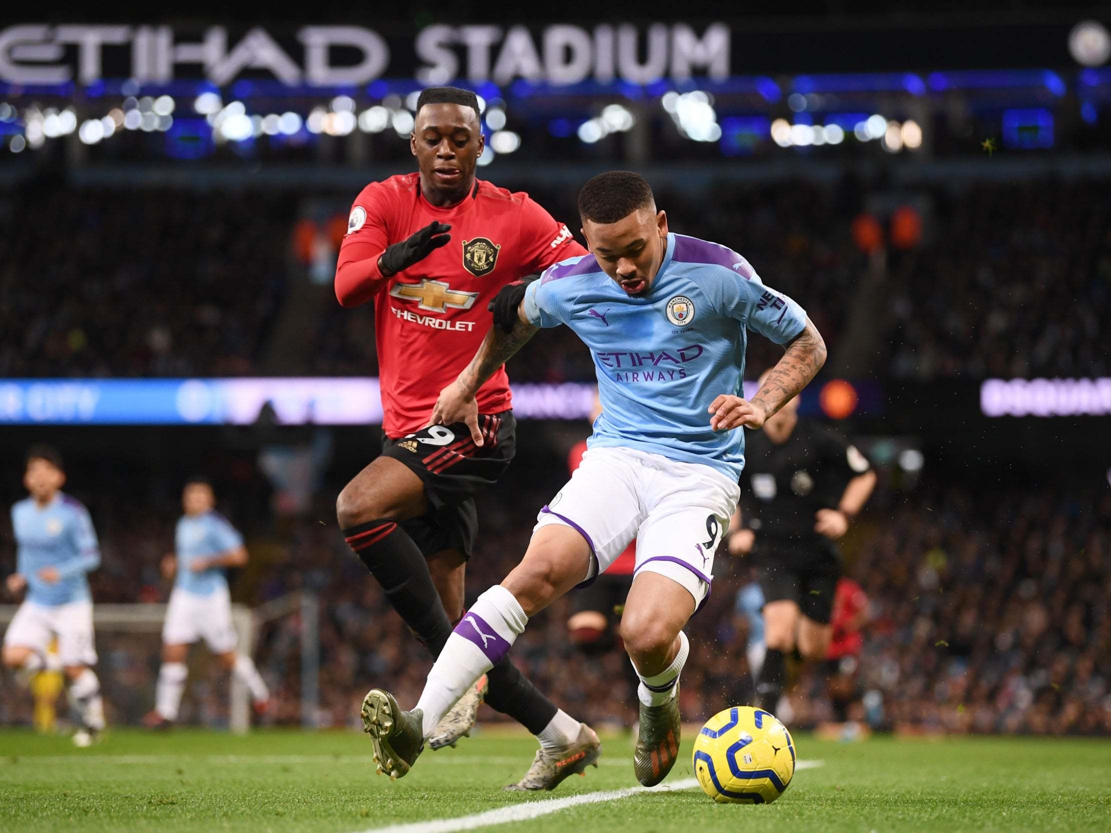 Gabriel Jesus shields the ball from Aaron Wan-Bissaka