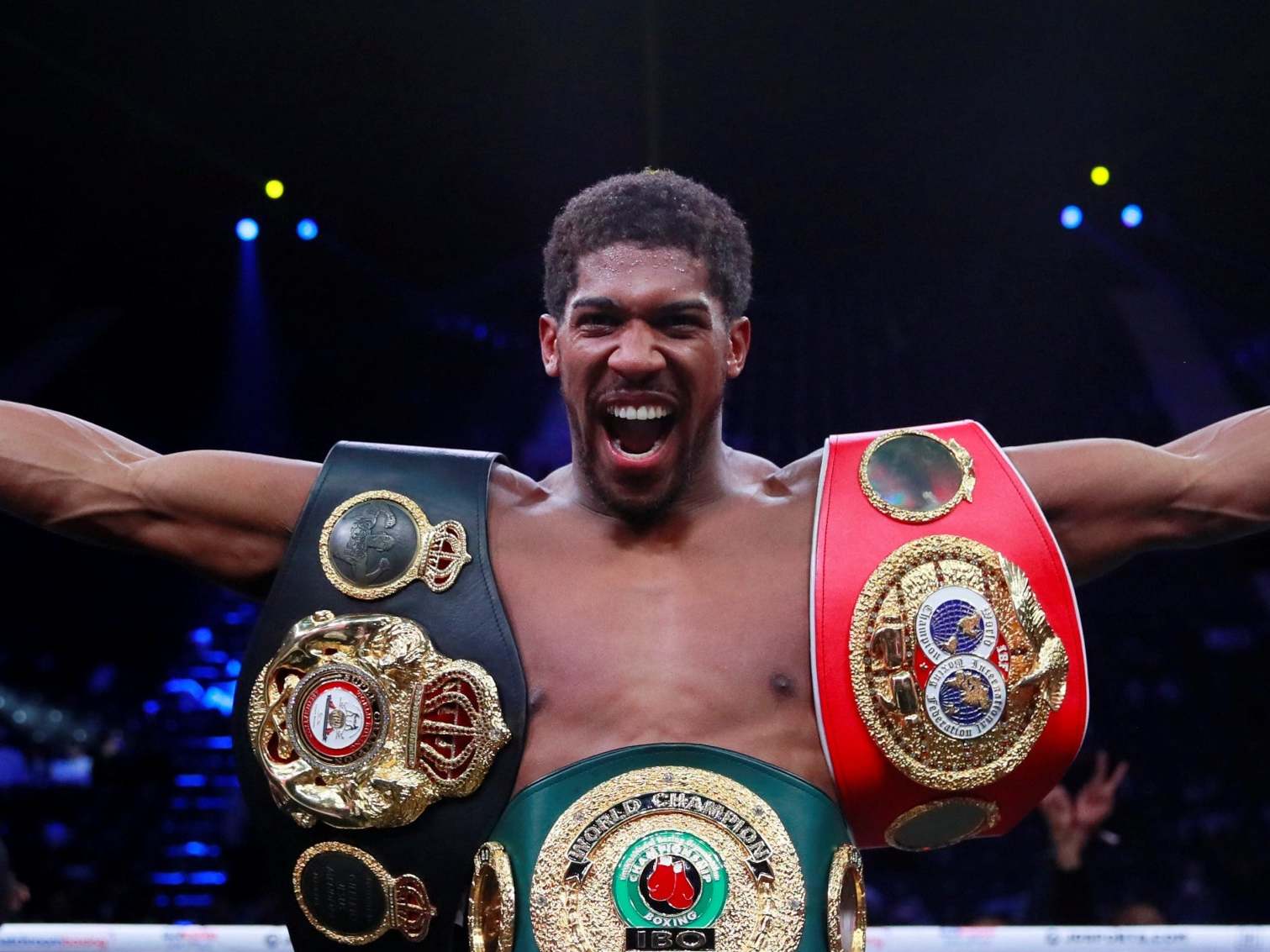 Joshua celebrates with his titles after beating Ruiz