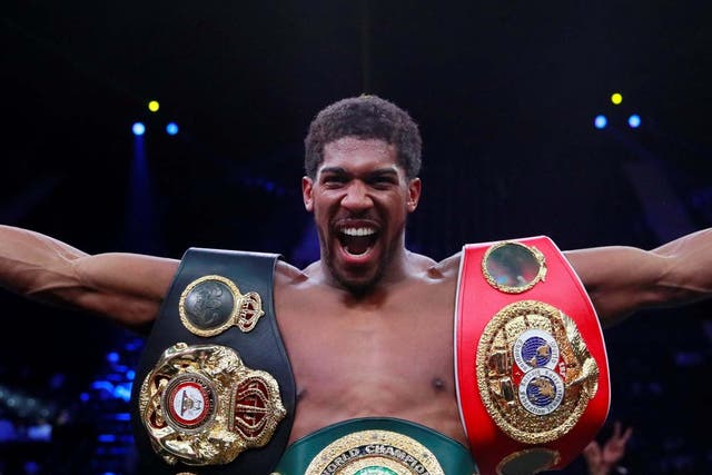 Joshua celebrates with his titles after beating Ruiz