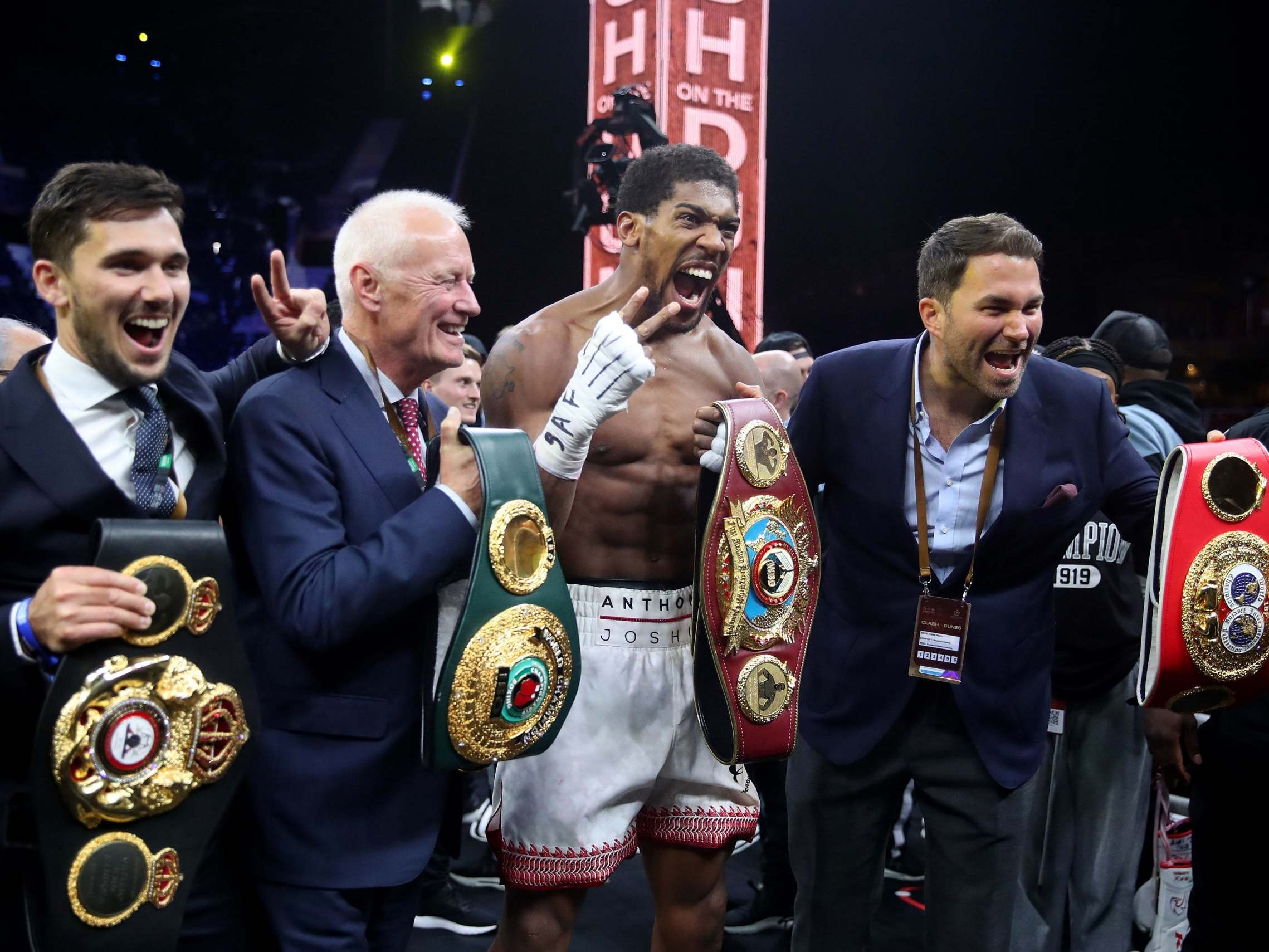 Anthony Joshua celebrates with his promoters after the fight