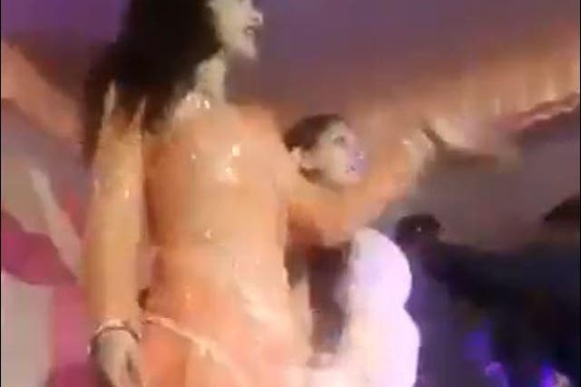 The woman is seen performing in a video of the incident before pausing for a while and being shot