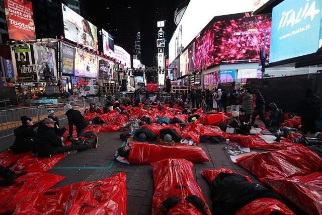 Participants set up sleeping bags during the The World’s Big Sleep Out at Times Square on Saturday