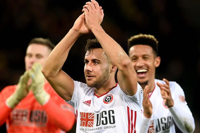 George Baldock celebrates after his goal earned Sheffield United victory at Norwich
