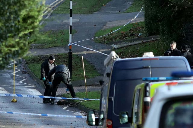Police hunt for clues in the road where a 25-year-old woman was stabbed to death