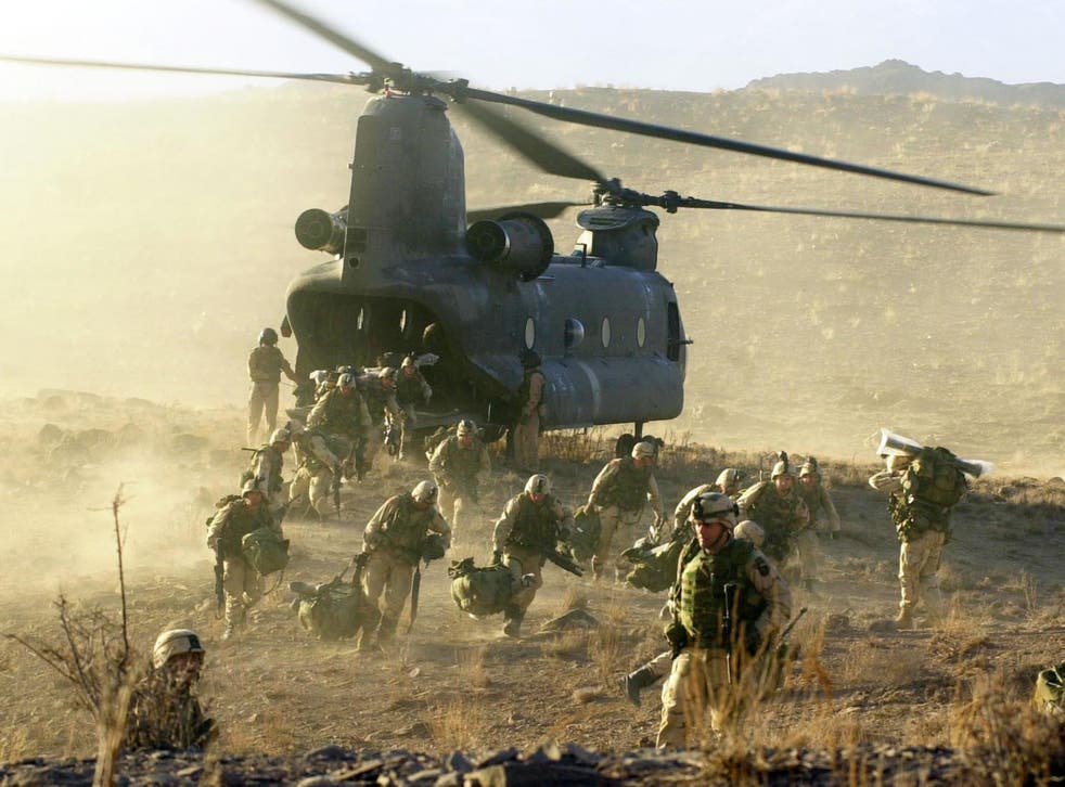 US soldiers off load from a Chinook 47 helicopter in Eastern Afghanistan in 2002