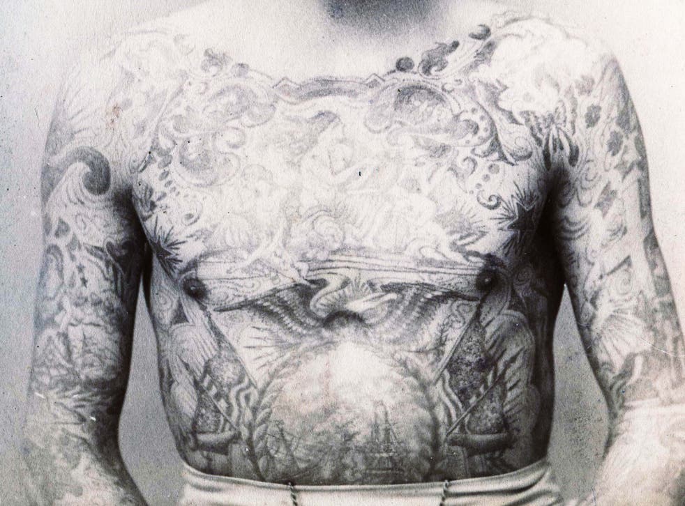 Cabinet photograph, by Eisenmann, of a young man with his entire chest and arms tattooed in New York, circa 1890
