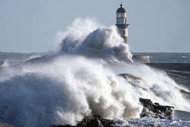 Waves crash against the pier wall at Seaham Lighthouse on the County Durham coast