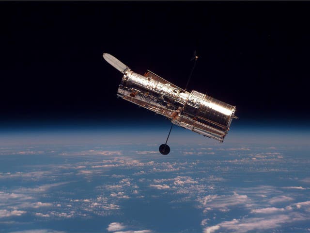 The Hubble Space Telescope begins its separation from Space Shuttle Discovery