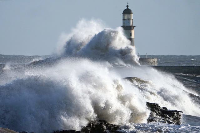 Waves crash against the pier wall at Seaham Lighthouse on the County Durham coast on Monday