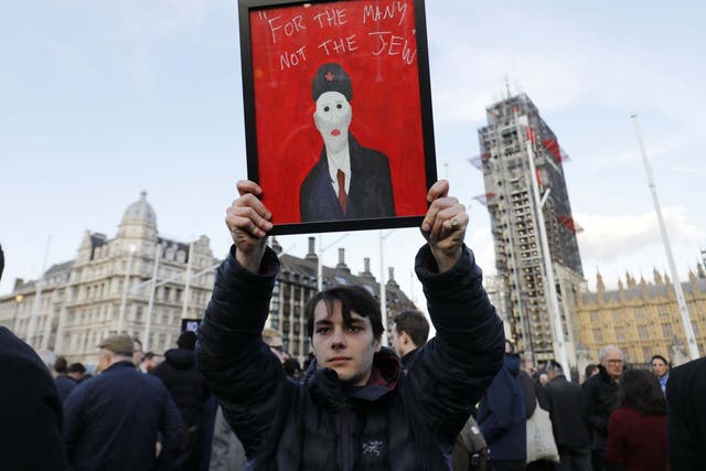 Members of the Jewish community hold a protest against antisemitism in the Labour party outside the Houses of Parliament on March 26, 2018.