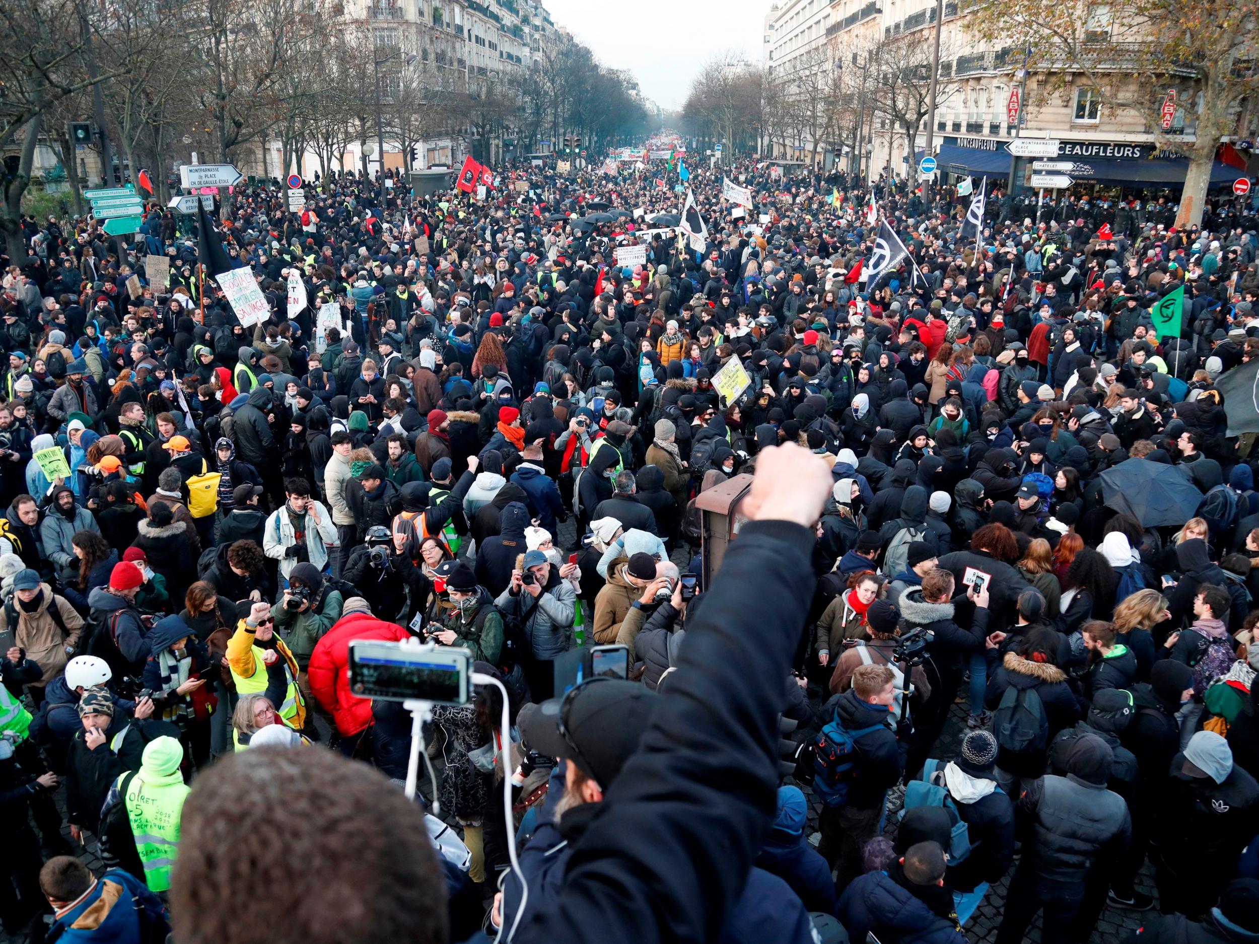 People take part in a demonstration in Paris on Tuesday, the sixth day of massive strike action over the government's proposed pension reforms