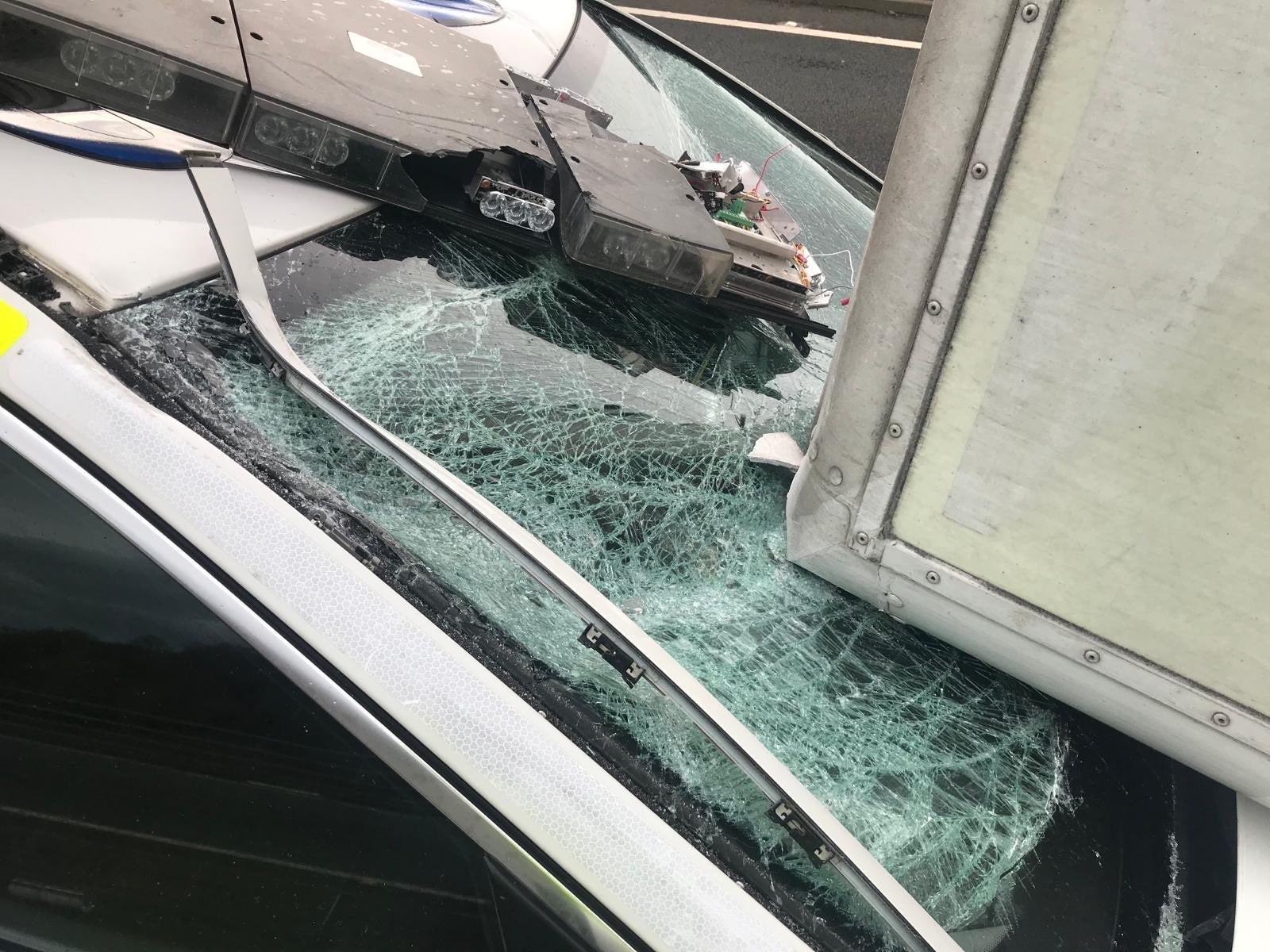 A police car was crushed by a lorry after it was blown over by strong winds on the A1 in Scotland while he was attending to another toppled HGV on 10 December, 2019.