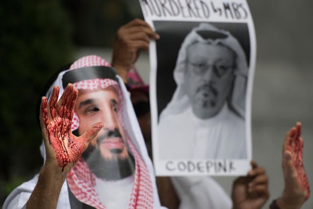 A demonstrator dressed as the crown prince with blood on his hands outside the Saudi embassy