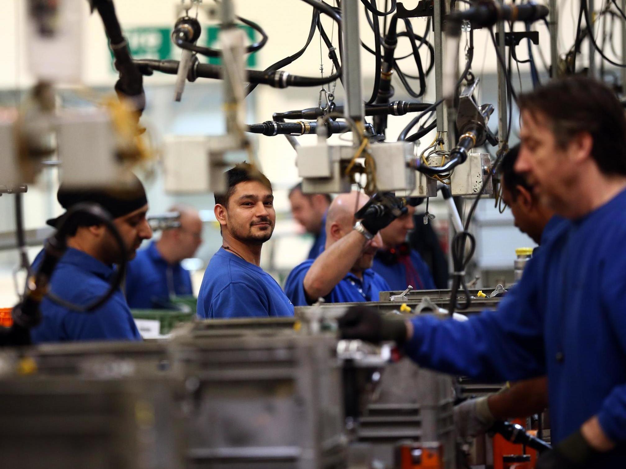 An employee works on an engine production line at a Ford factory on 13 January, 2015 in Dagenham, England