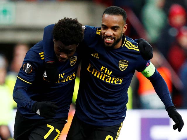 Alexandre Lacazette, right, celebrates with Bukayo Saka