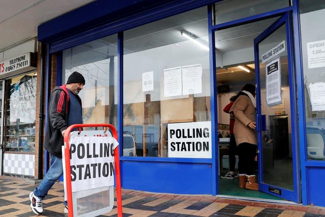 People arrive to cast their votes at a polling station during the general election