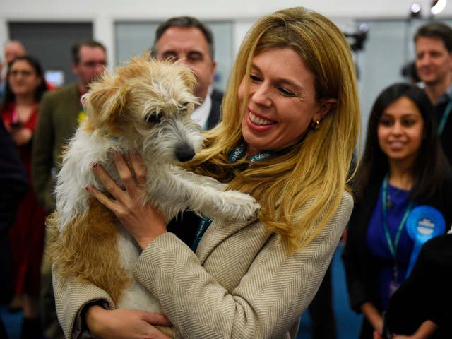 Carrie Symonds holds her dog Dilyn, as she arrives at the vote count centre in Uxbridge, west London