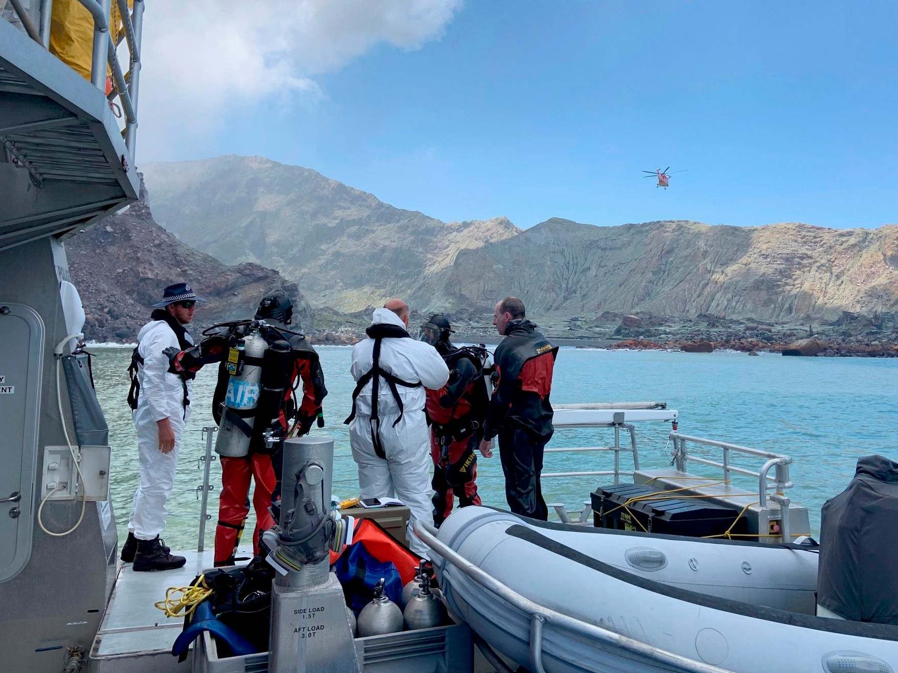 Police divers prepare to search the waters near White Island off the coast of Whakatane, New Zealand, Saturday, 14 December 2019.