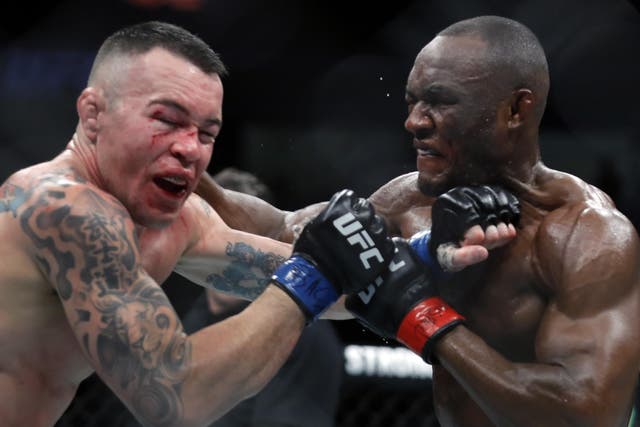 Kamaru Usman (right) finished Colby Covington late in the pair's UFC 245 main event to retain the welterweight title.
