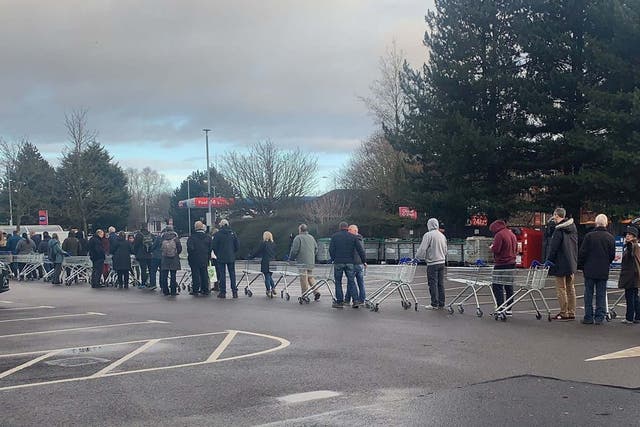 People queue for bottled water at the Tesco on Vimy Road in Leighton Buzzard after thousands were left without water